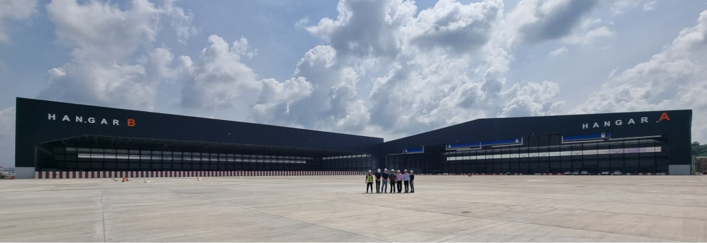 Engineers standing near hangar